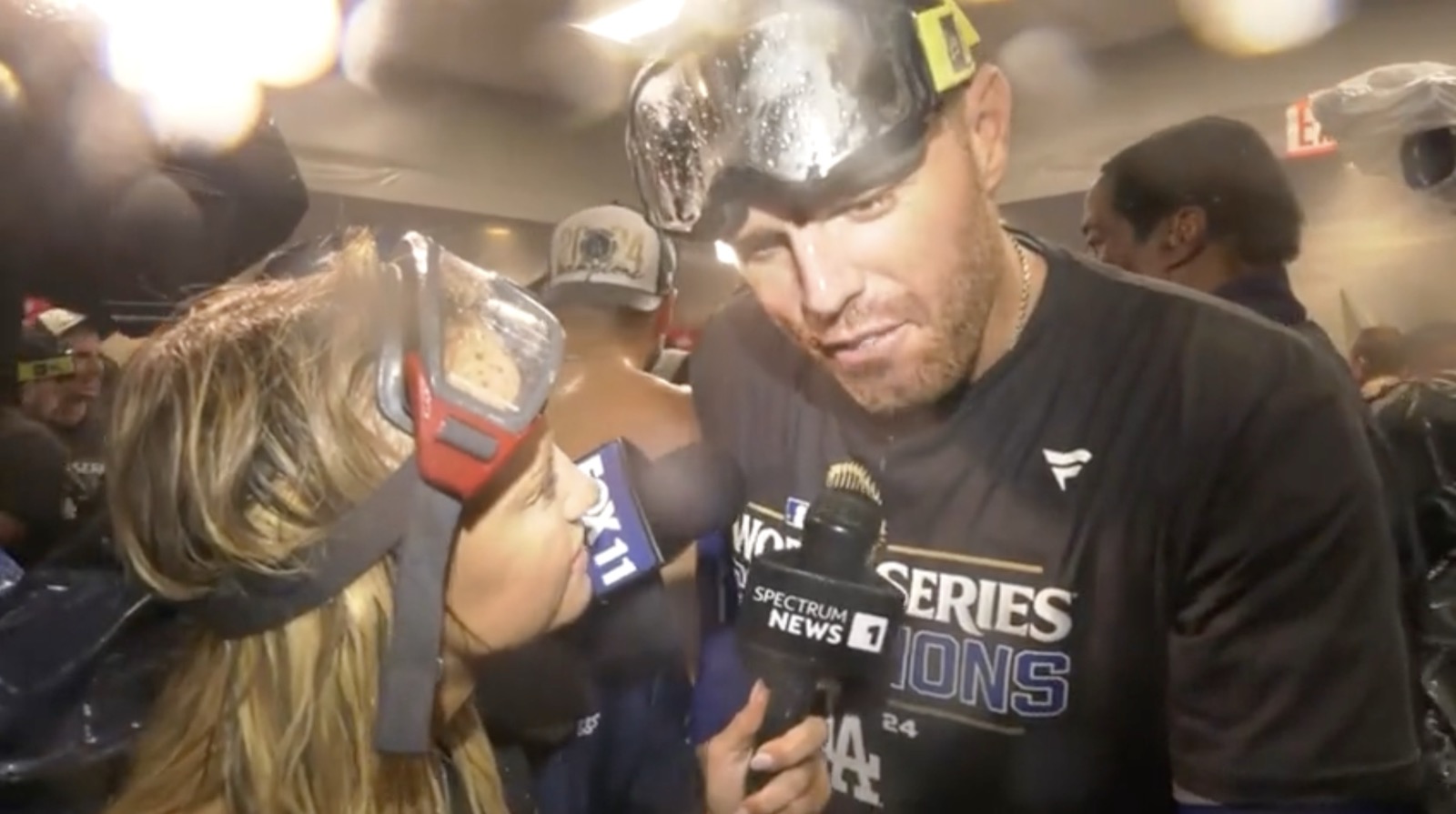 Nikki Kay interviewing a Dodgers player in the World Series championship celebration